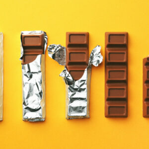 tasty chocolate bars on yellow background, flat lay