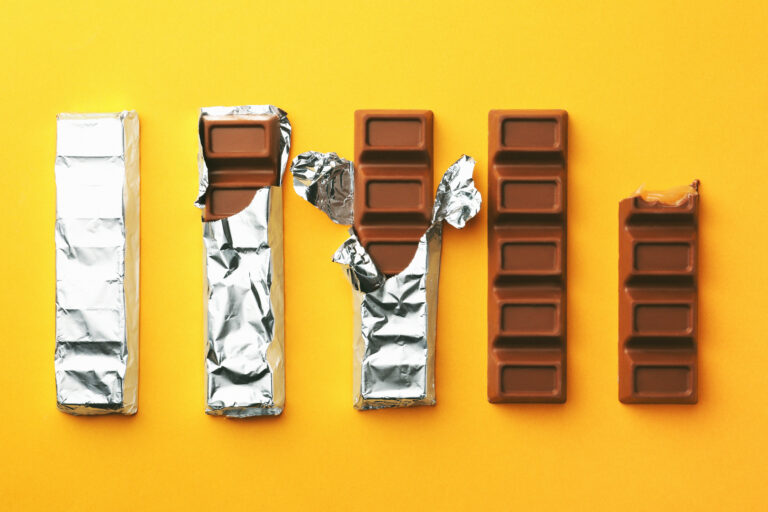 tasty chocolate bars on yellow background, flat lay